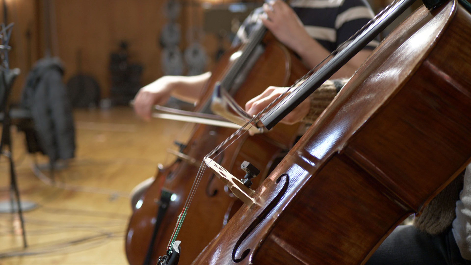 Synchron Percussion II: A variety of orchestral percussion instruments, including gongs, cymbals, and small bells, arranged on stands in a recording studio or concert hall.