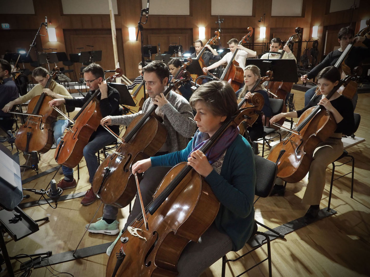 Synchron Percussion II: A variety of orchestral percussion instruments, including gongs, cymbals, and small bells, arranged on stands in a recording studio or concert hall.