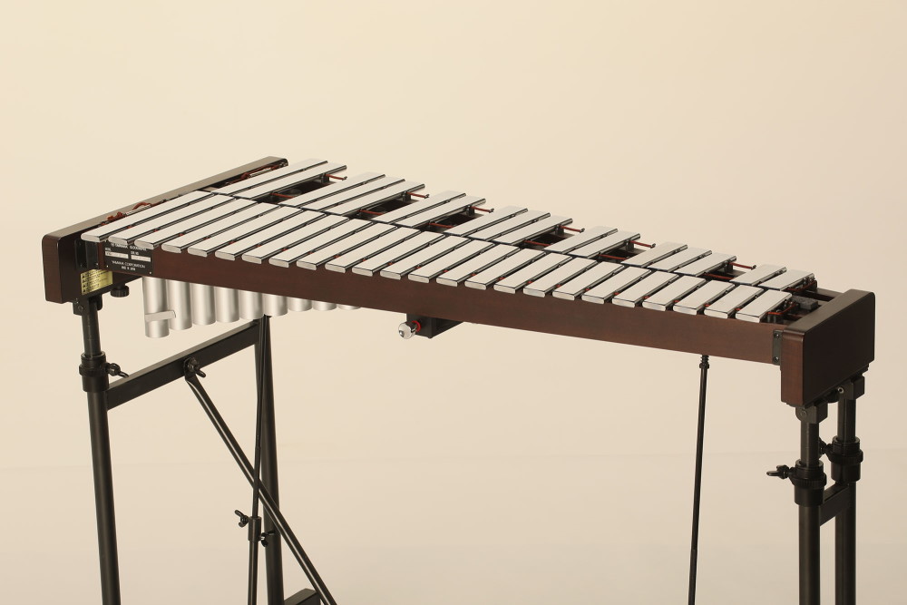 Glockenspiel musical instrument with two rows of metal bars in a wooden case, ideal for orchestral use and music education.