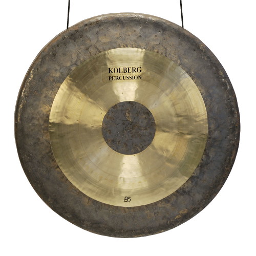Two dark gongs hanging in front of a black background, one slightly smaller and higher than the other. Both have large light-colored rings around their dark centers.
