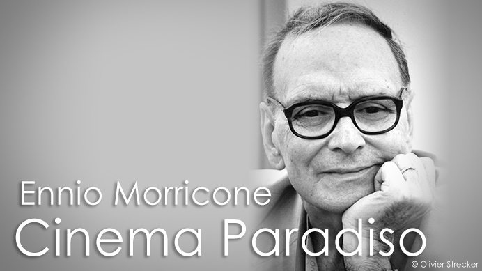 Black and white portrait of composer Ennio Morricone wearing glasses, with text Ennio Morricone Cinema Paradiso.