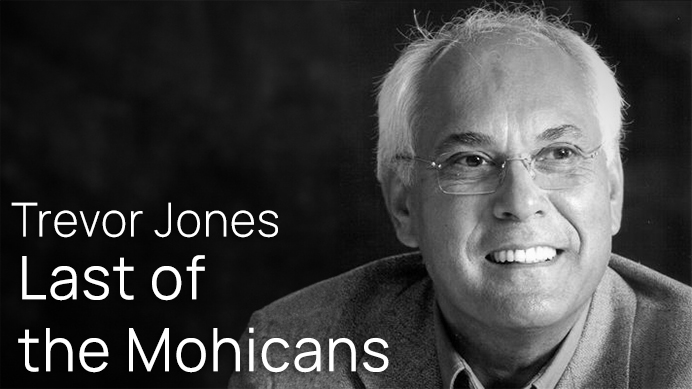 Black and white portrait of composer Trevor Jones, smiling and wearing glasses, promoting his work Last of the Mohicans.