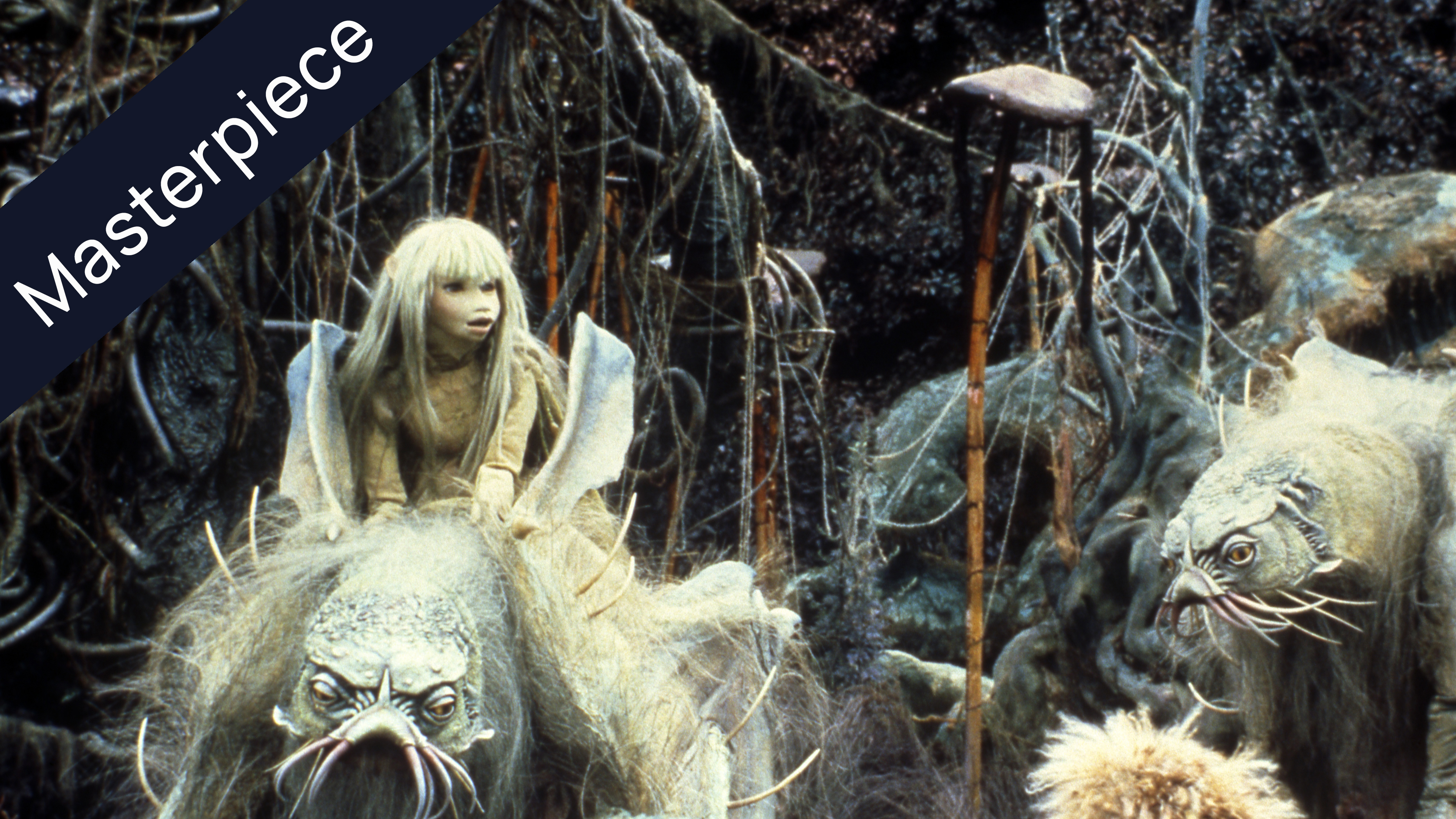 Jen, a Gelfling with long blonde hair, rides atop a large, furry Landstrider creature, while another Landstrider stands nearby. The background features a dark, overgrown forest with intertwining roots and branches typical of The Dark Crystal movie setting. A Masterpiece banner is overlaid on the top left.