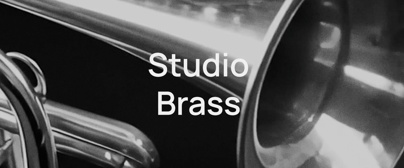 Close-up of shiny brass musical instrument with Studio Brass text
