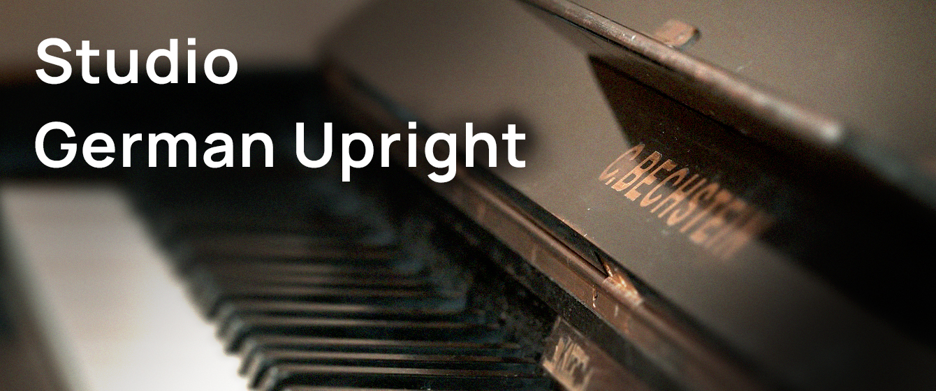 Close-up view of a dark German upright piano keyboard and key cover, with the brand name 'C. BECHSTEIN' visible.